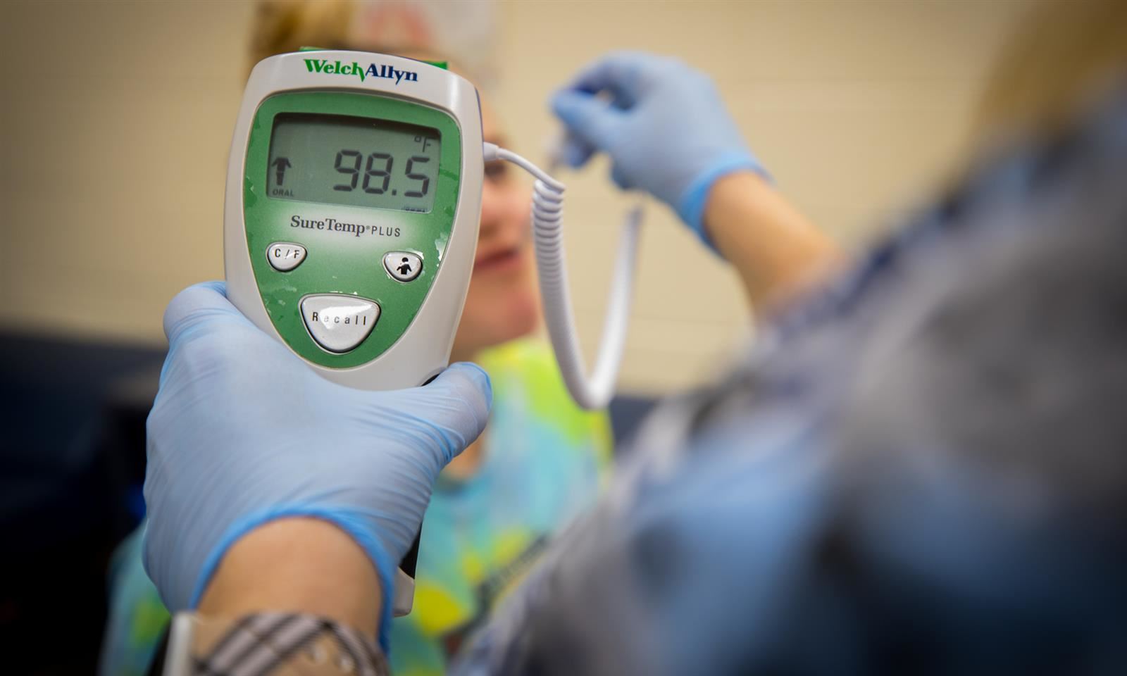 A student's temperature is taken in the nurse's office